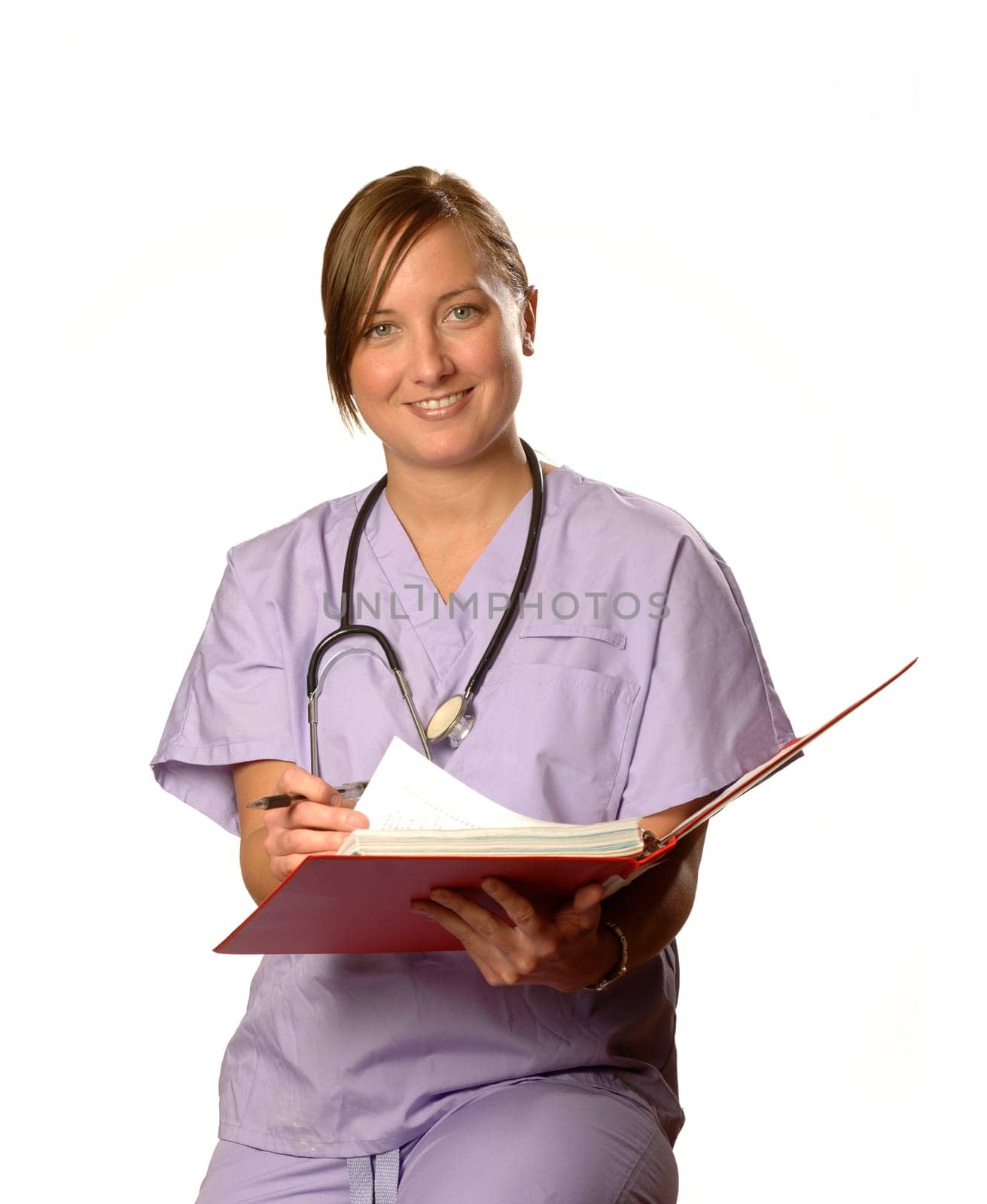 a nurse looks up from her notes against white