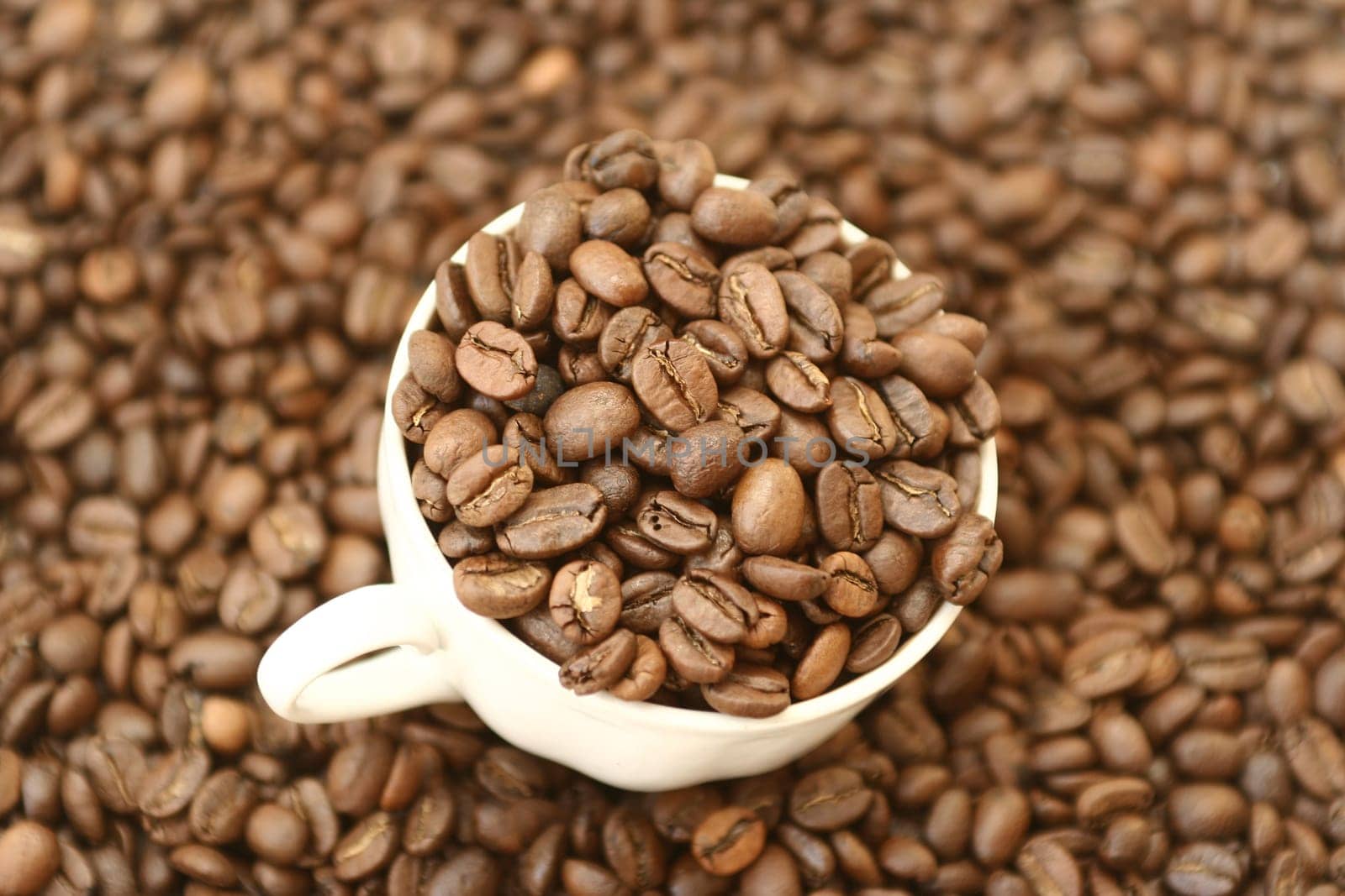 Full cup with grains of coffee