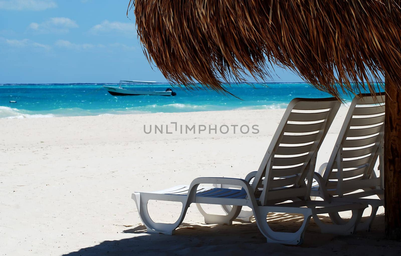 two seats under wicker umbrella