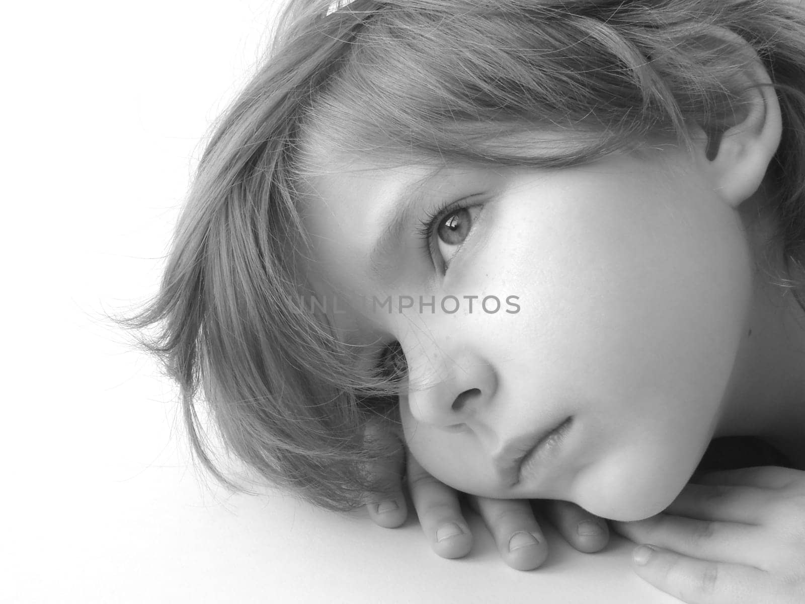 black and white portrait of the small pretty thoughtful girl