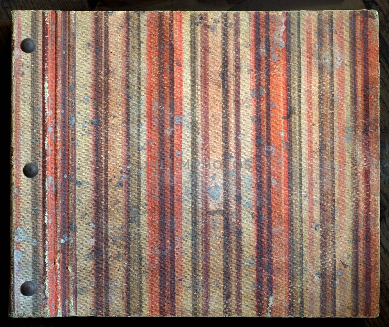 Old rugged, damaged and stained book cover.