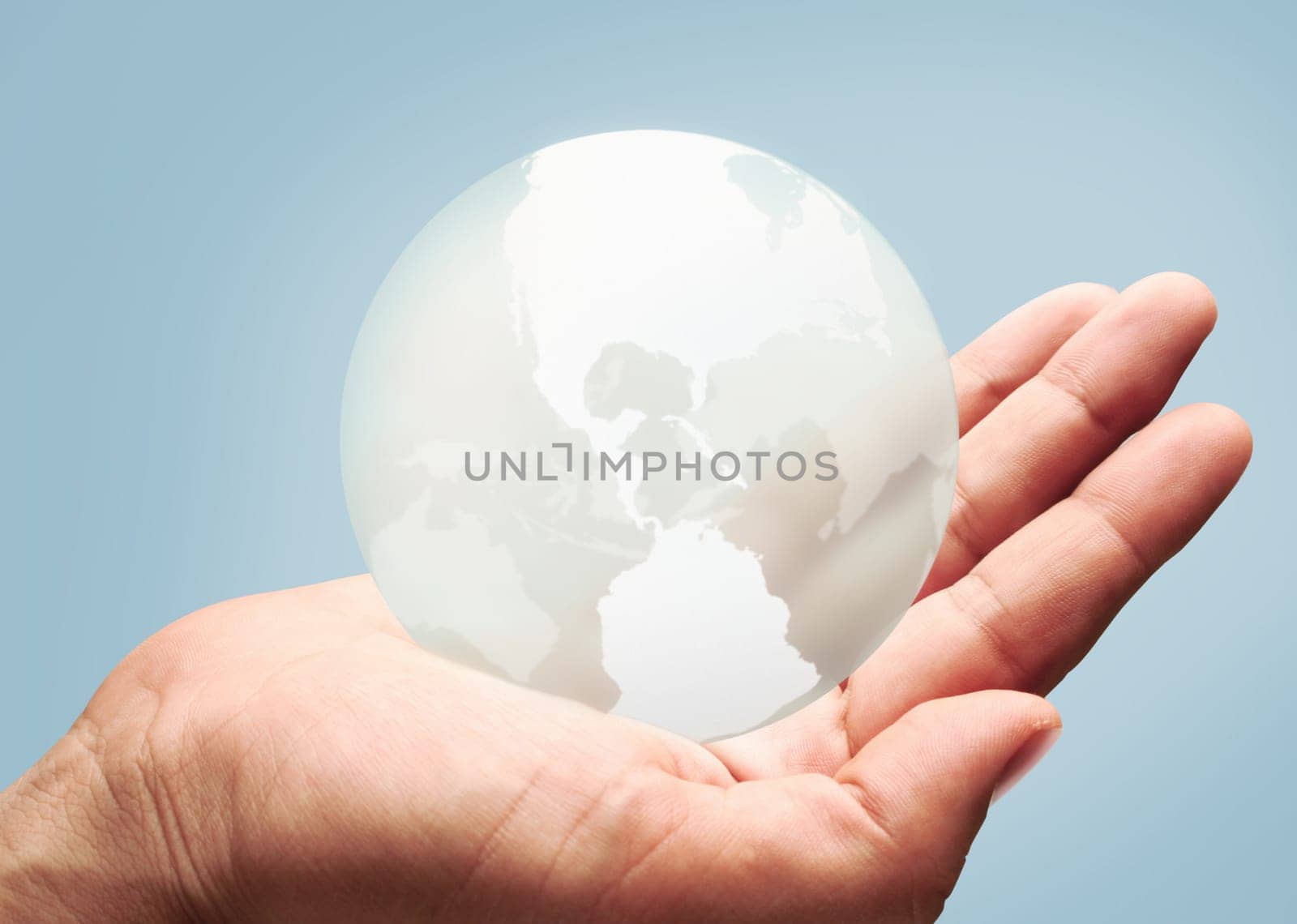 Hand holding globe