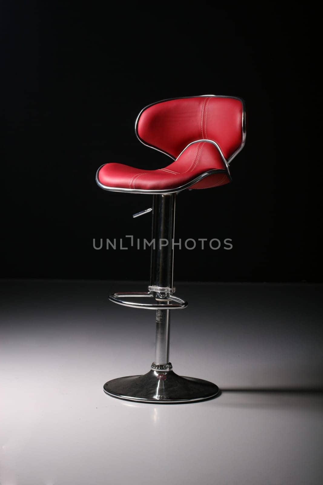 tall red bar chair in a studio