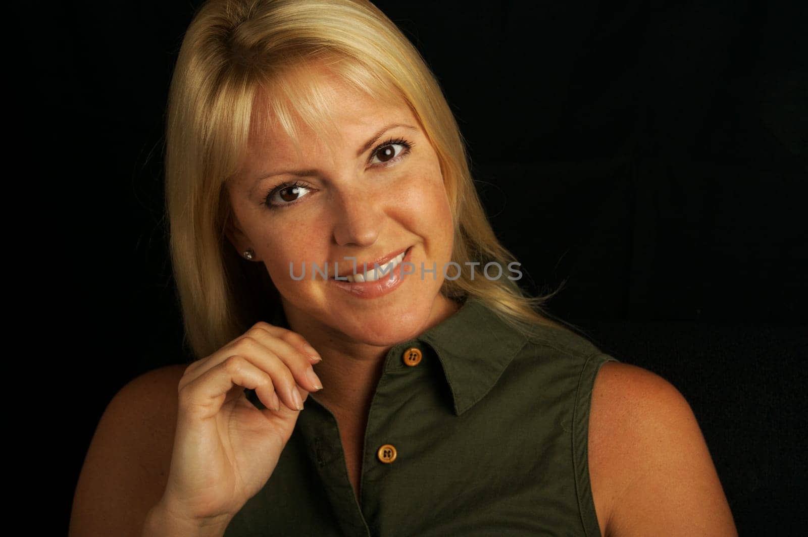 Attractive Blond Haired, Brown Eyed Woman on a black background.