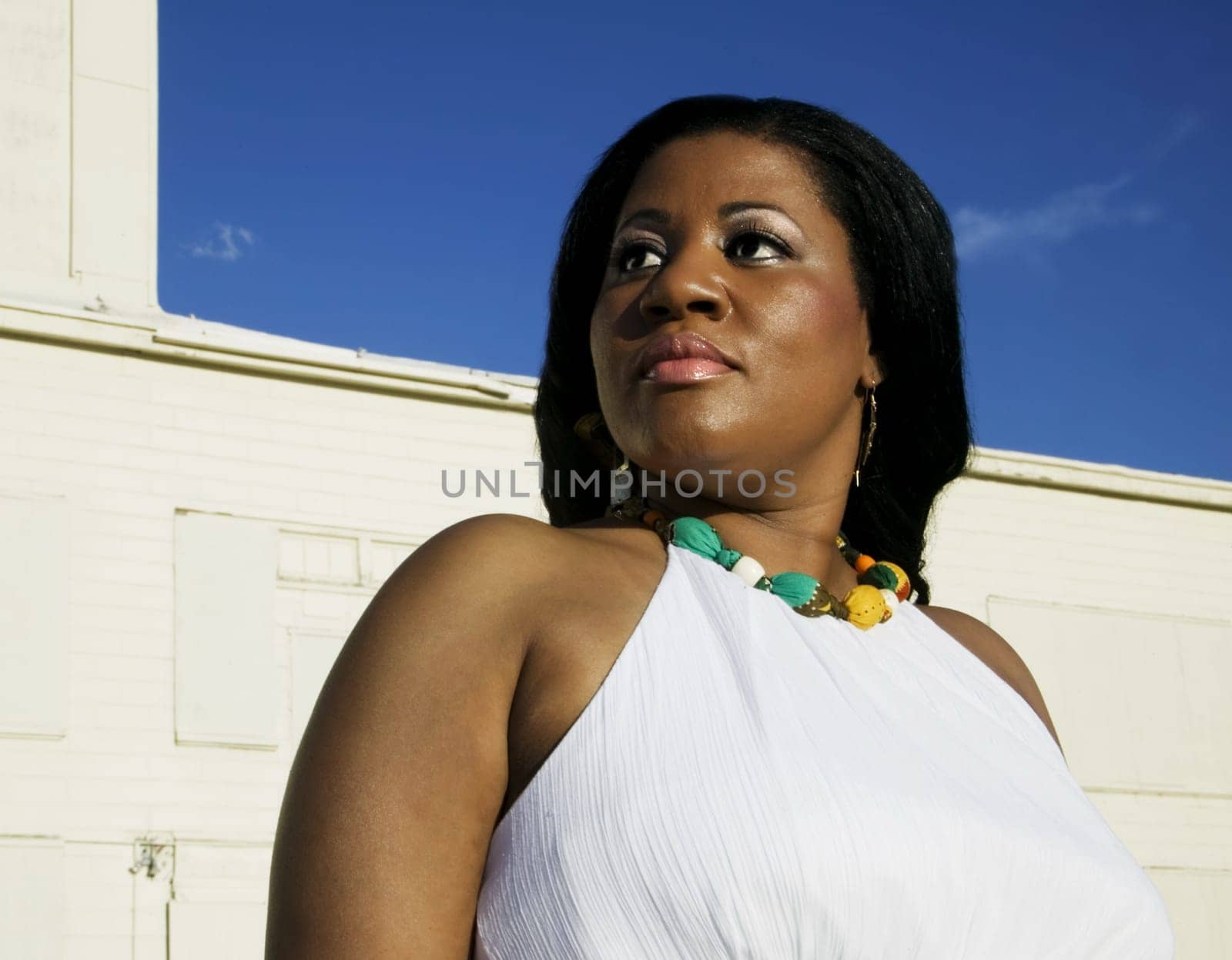 African American woman oustide in an industrial setting.