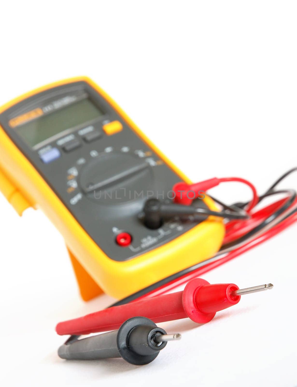 Digital multimeter with black and red probes over white background
