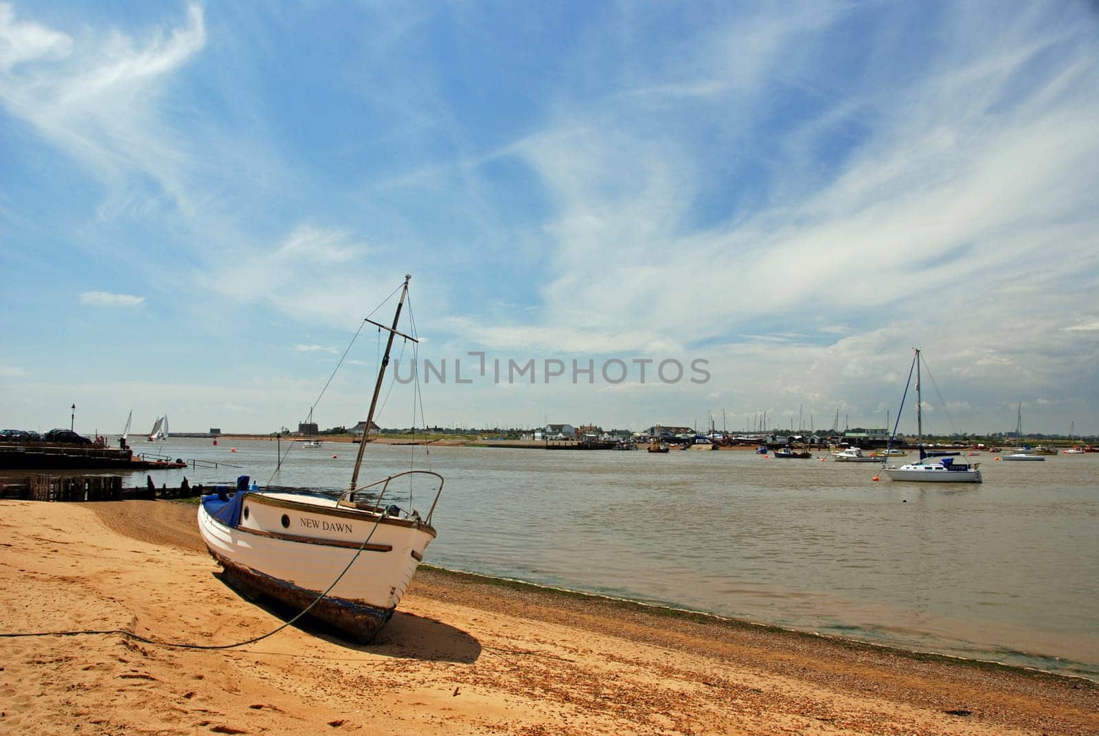 Wooden yacht stranded on beach on a sunny day