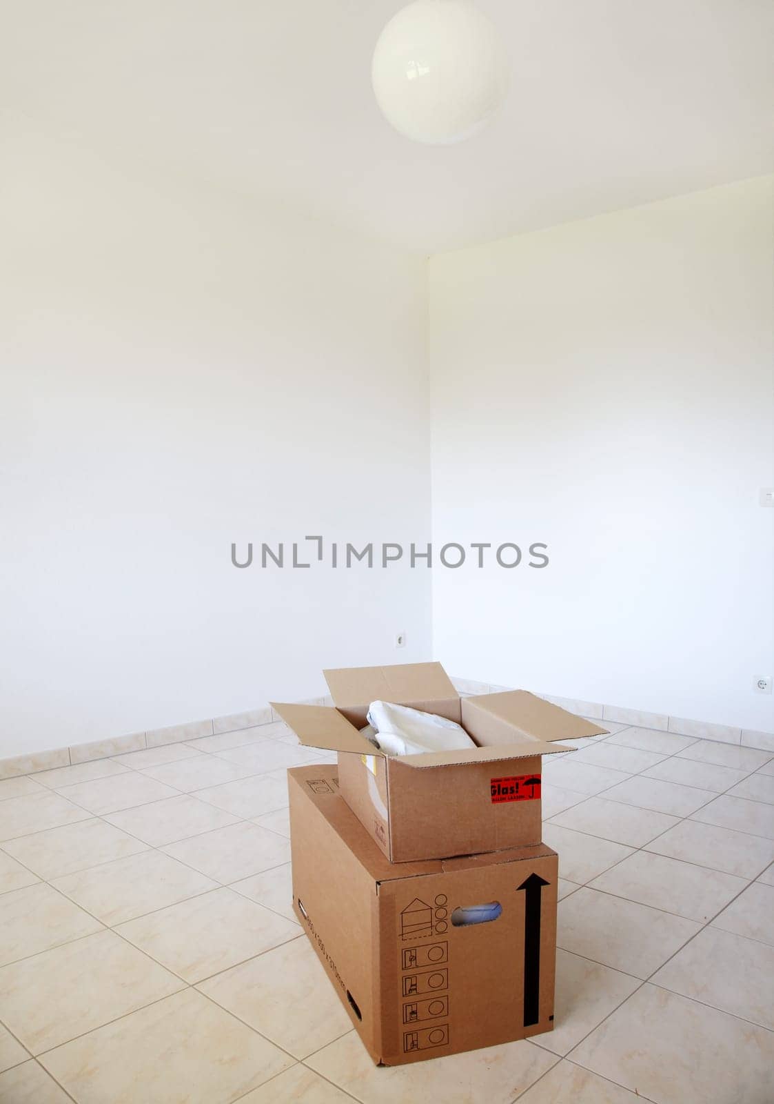 Concept of moving in or out - empty room with boxes