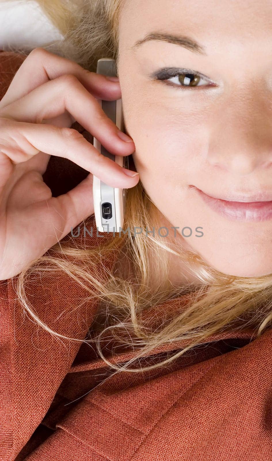 Businesswoman wearing red suit working using  mobile phone. Blong long hair.