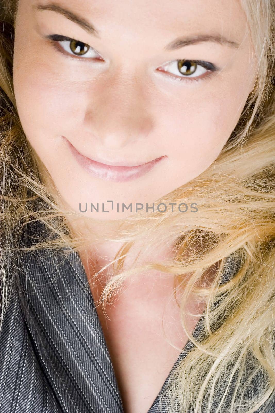 Elegant businesswoman wearing a suit. Blond long hair.