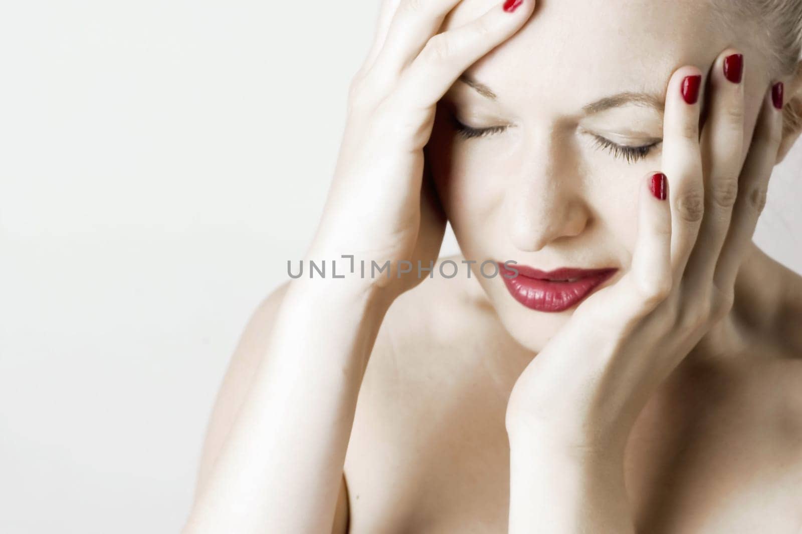 Beautiful sensual woman with headache/ pain. White background.