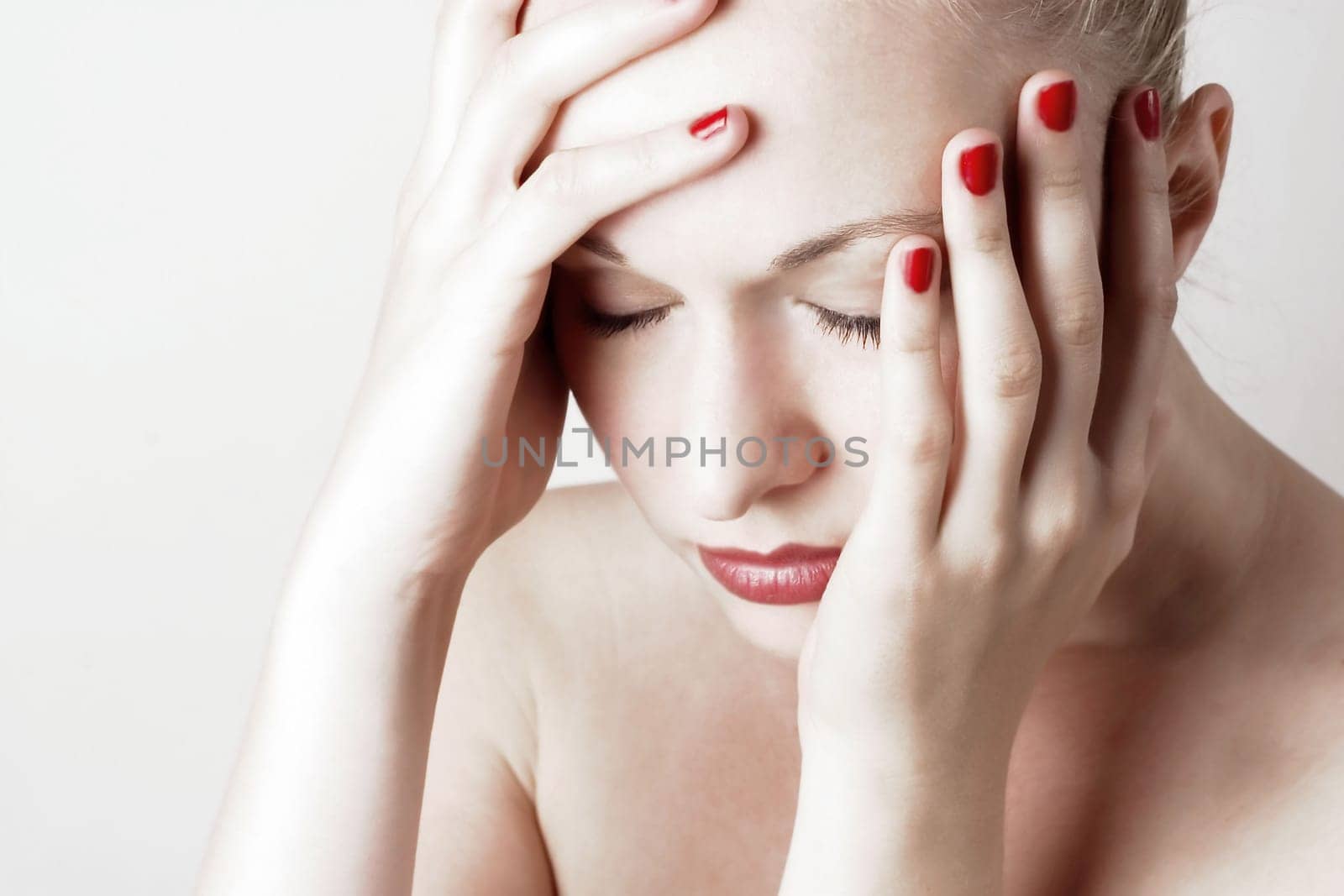 Beautiful sensual woman with headache/ pain. White background.