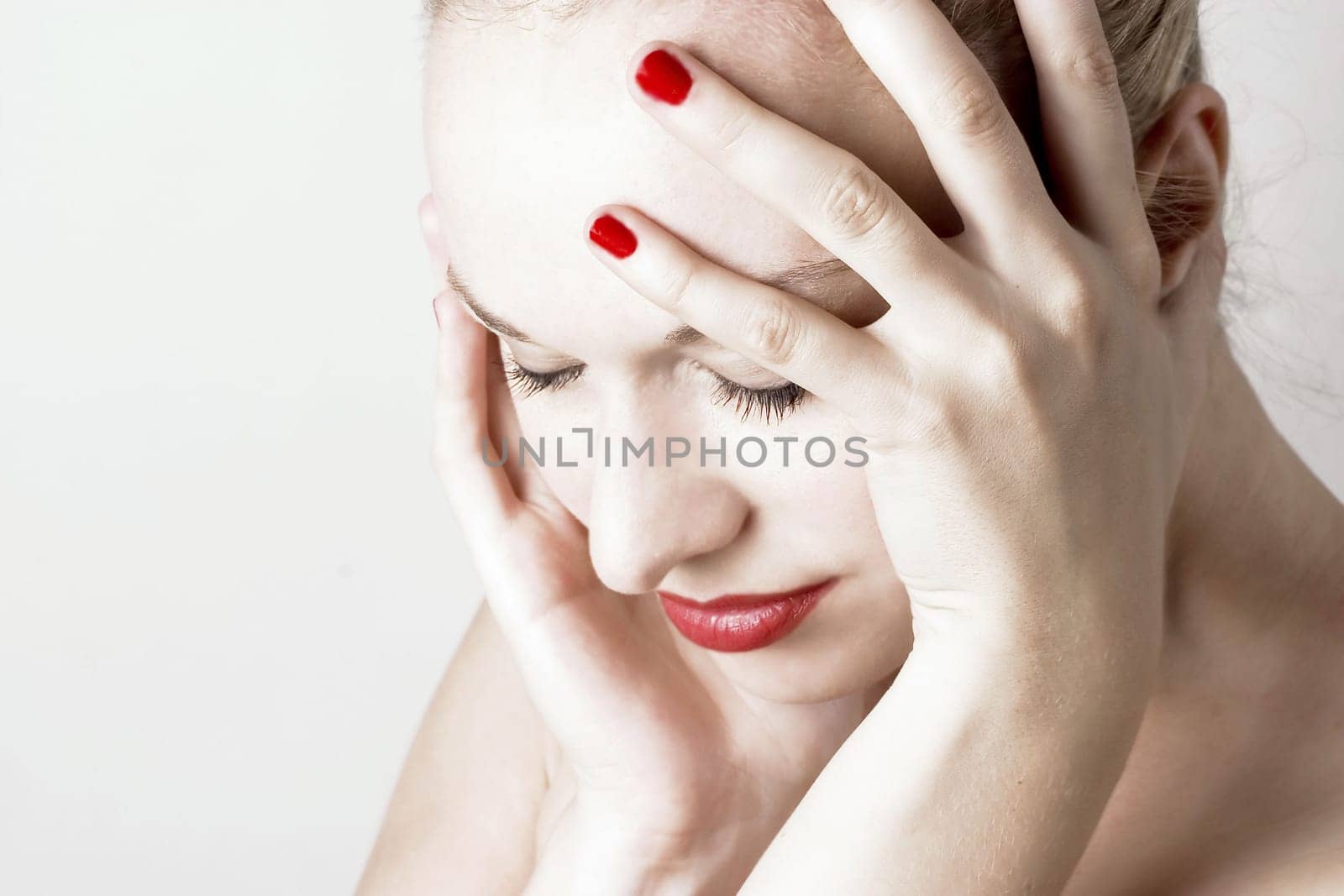 Beautiful sensual woman with headache/ pain. White background.