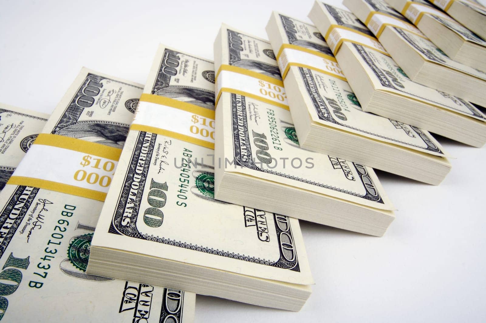 Stacks of One Hundred Dollar Bills on a white background