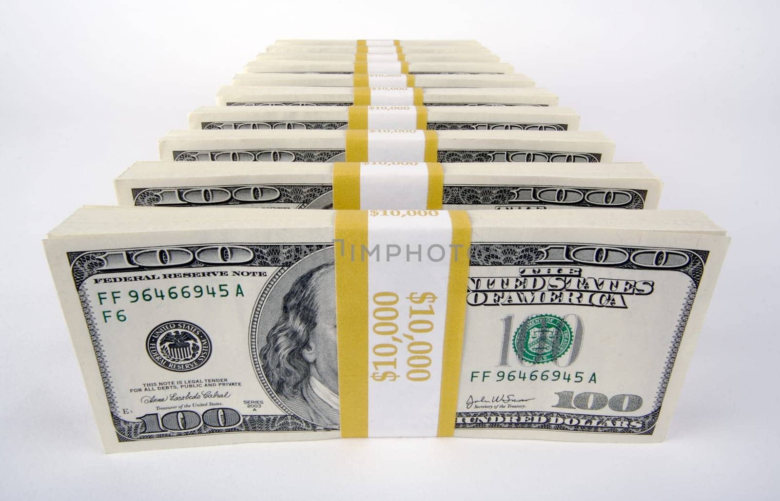 Stacks of One Hundred Dollar Bills on a white background