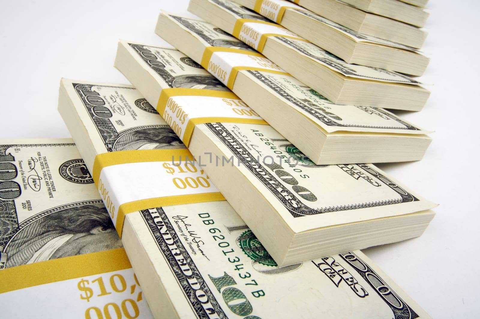 Stacks of One Hundred Dollar Bills on a white background