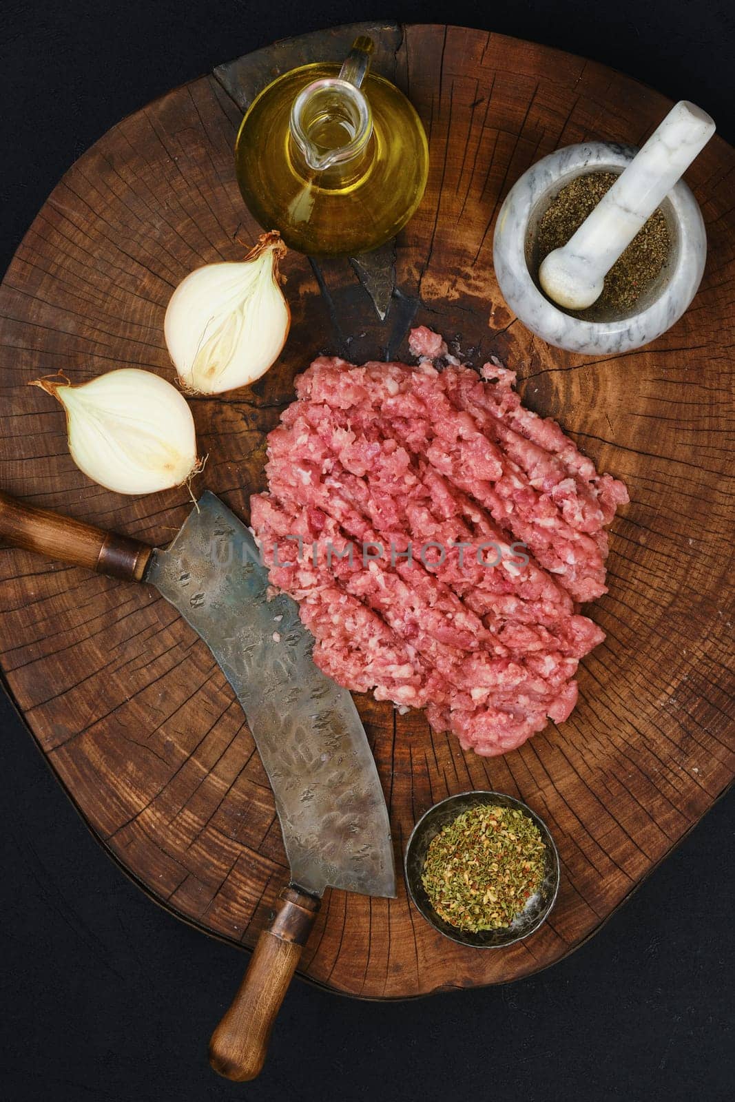 Making fresh raw beef mince meat with chopping knife, top view