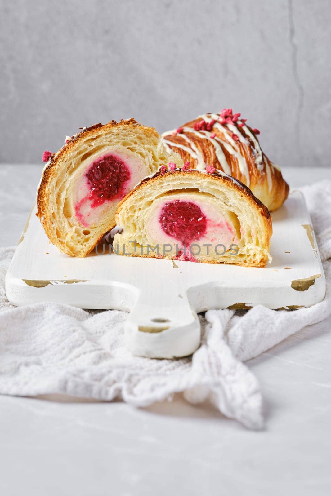 Croissant cut in half, showing the cross section with raspberry stuffing