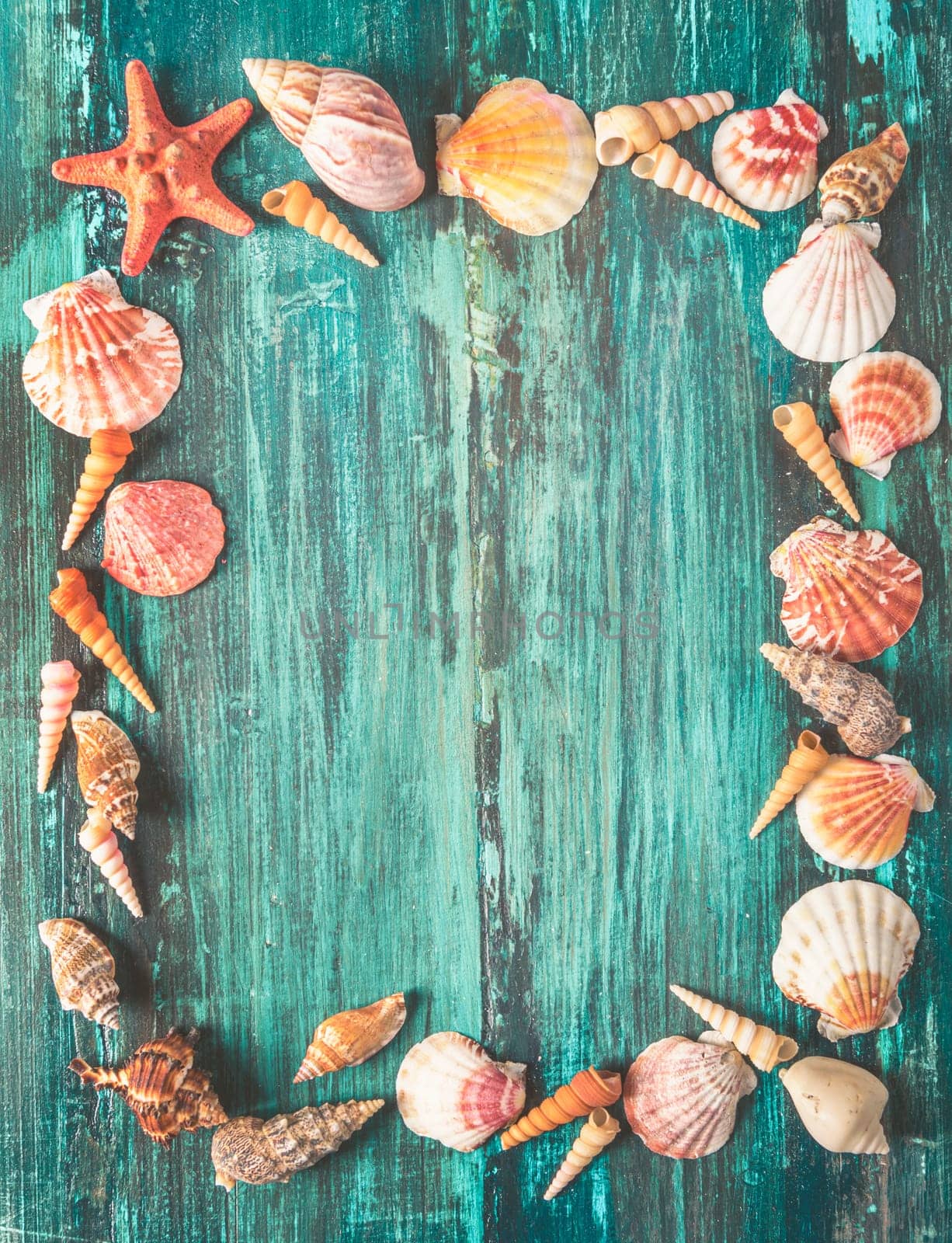 Seashell and star fish frame on rustic wooden texture background design with copyspace. Summer holiday and tropical beach travel concept. Retro filter.