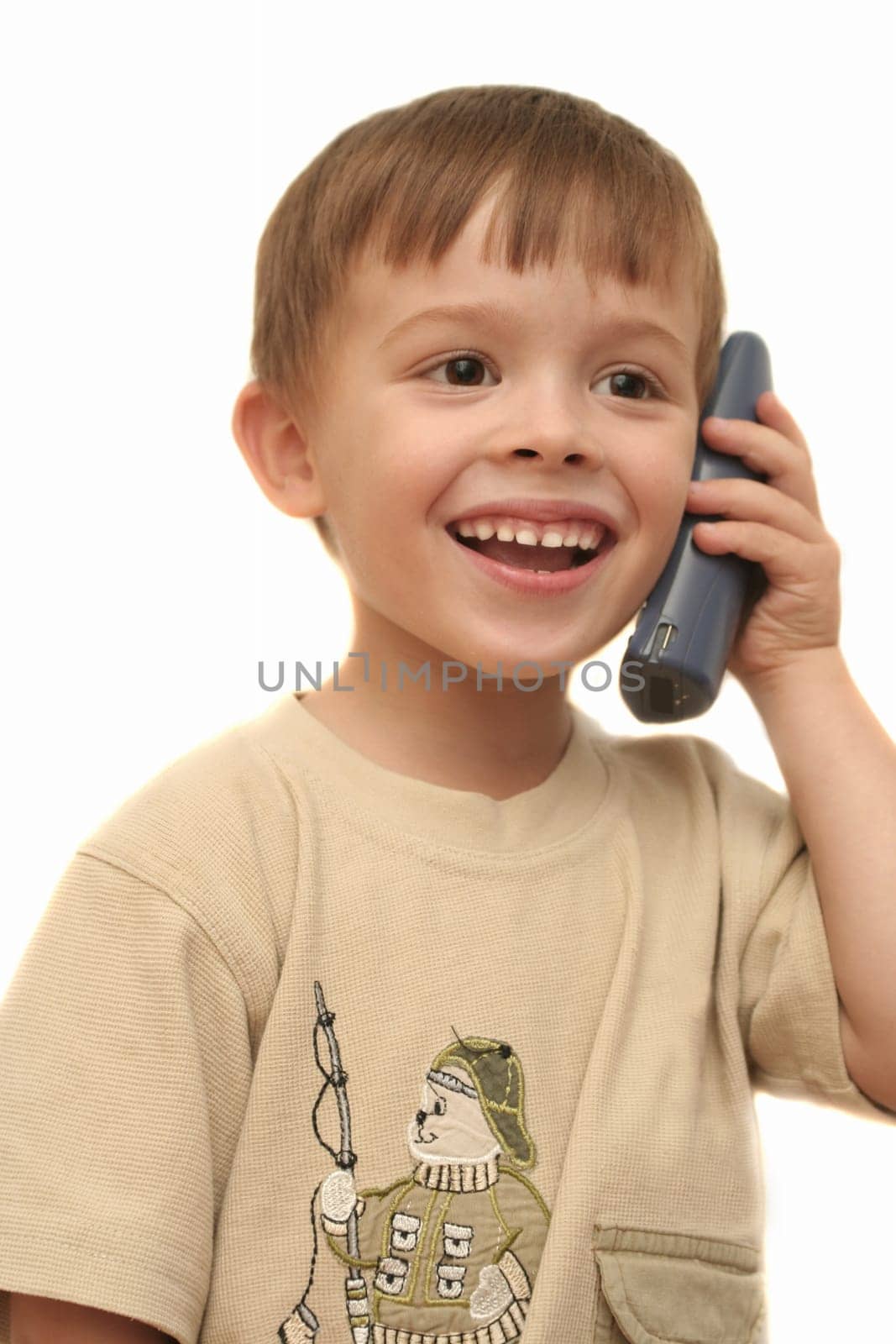 The nice boy speaks by phone on a white background