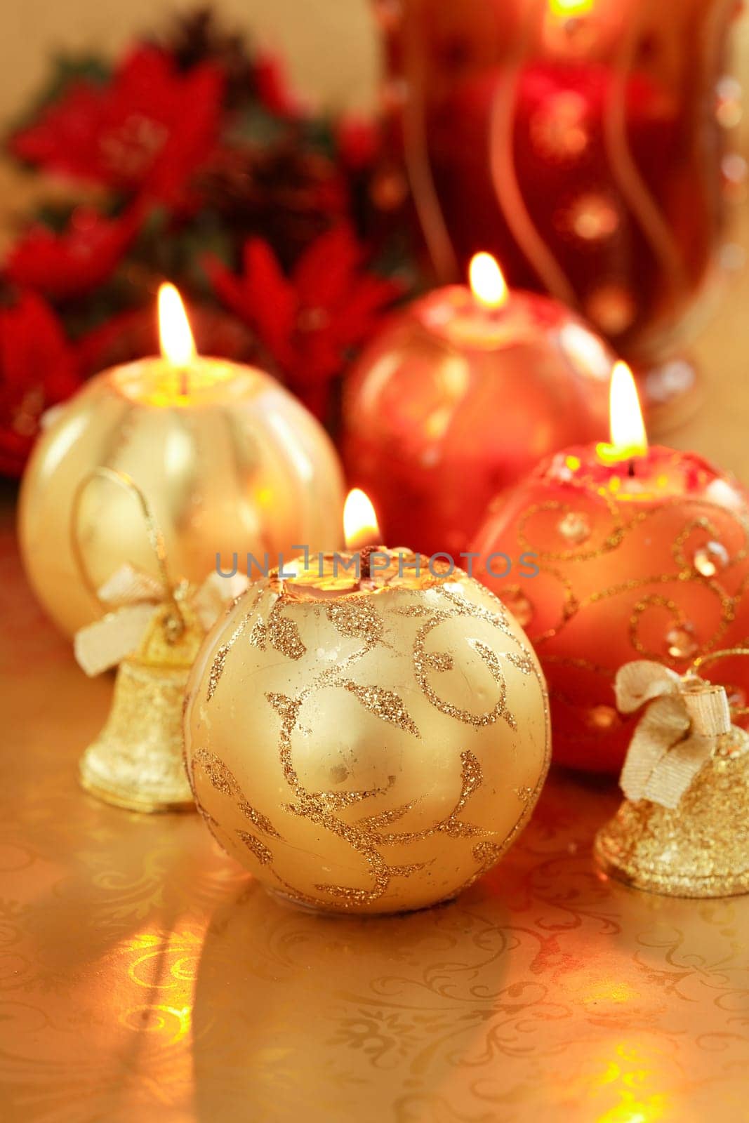 Beautiful Christmas candles in golden and red tones as decoration