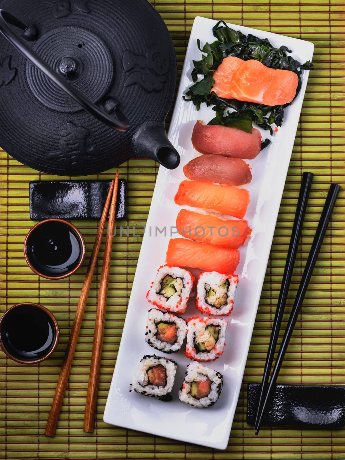 Top view of traditional japanese cuisine. Sushi set with salmon and tuna fish with chopsticks from above.
