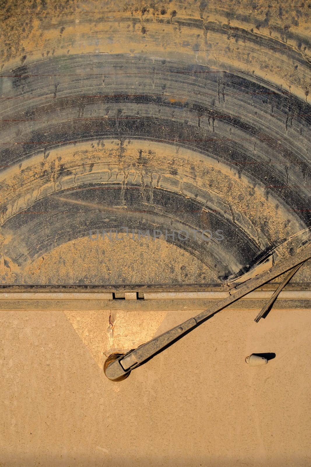 The dirty back window of an off-road sport utility vehicle.  Background image for off-road adventure.