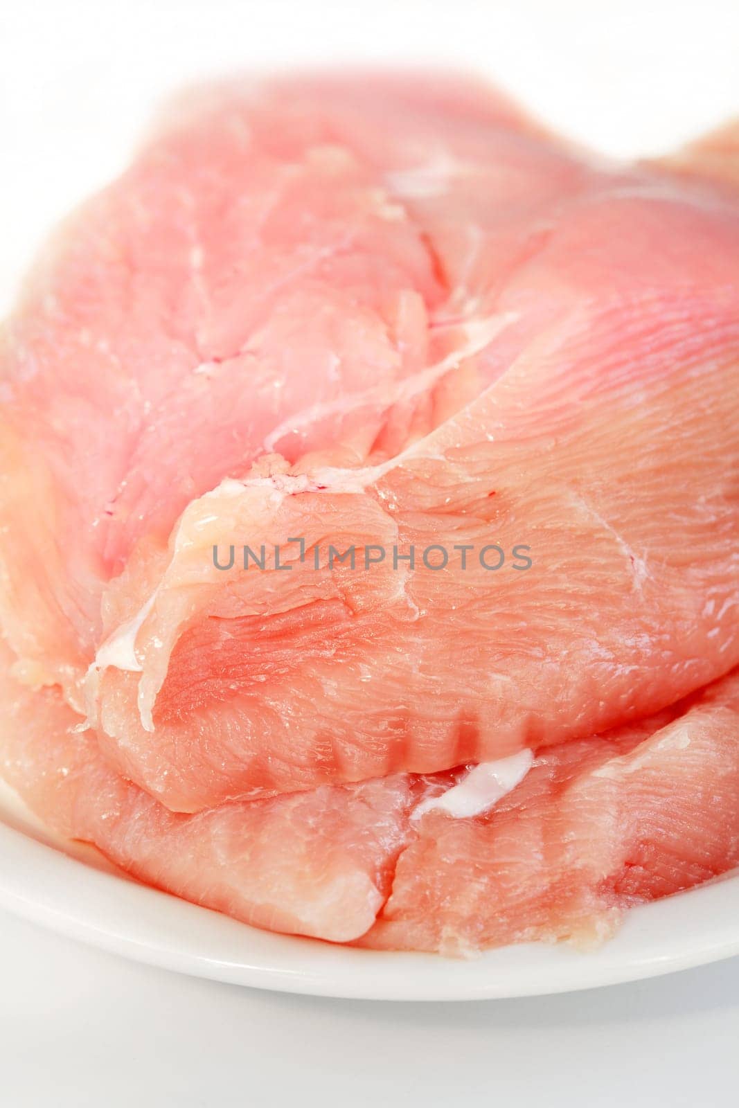 Raw turkey breast on the plate