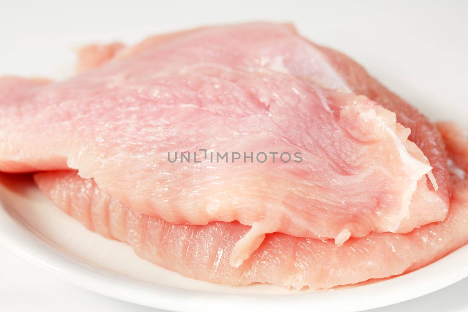 Raw turkey breast on the plate