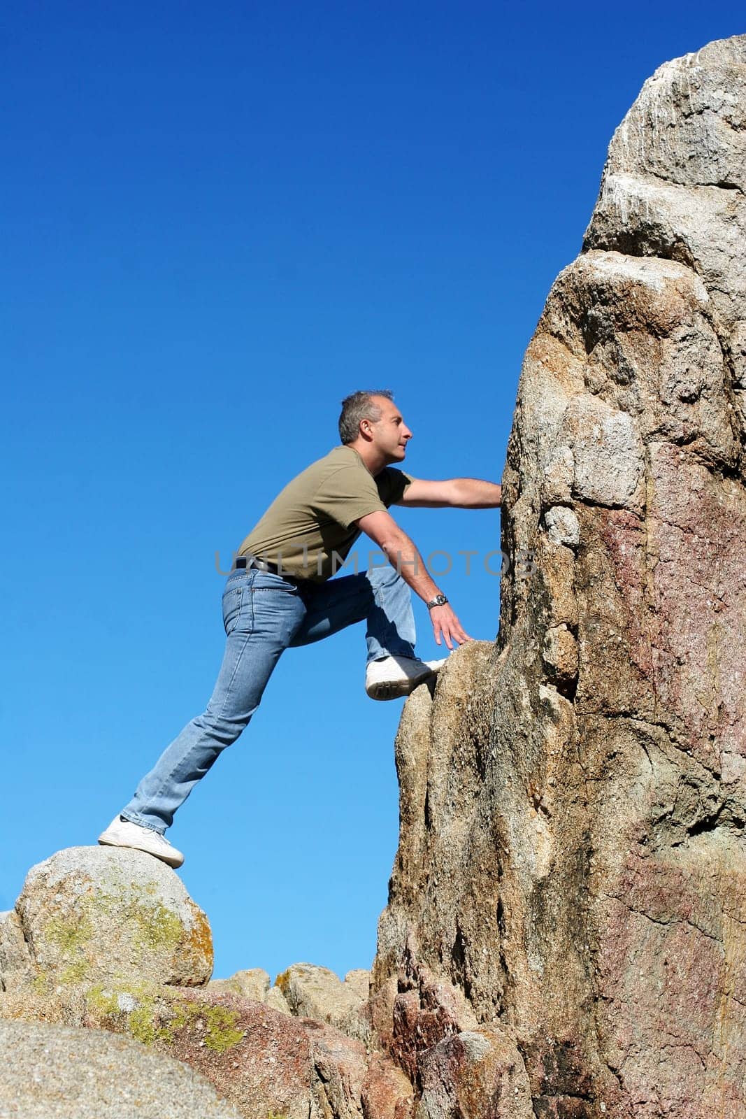 Man climbing to the top of the mountain