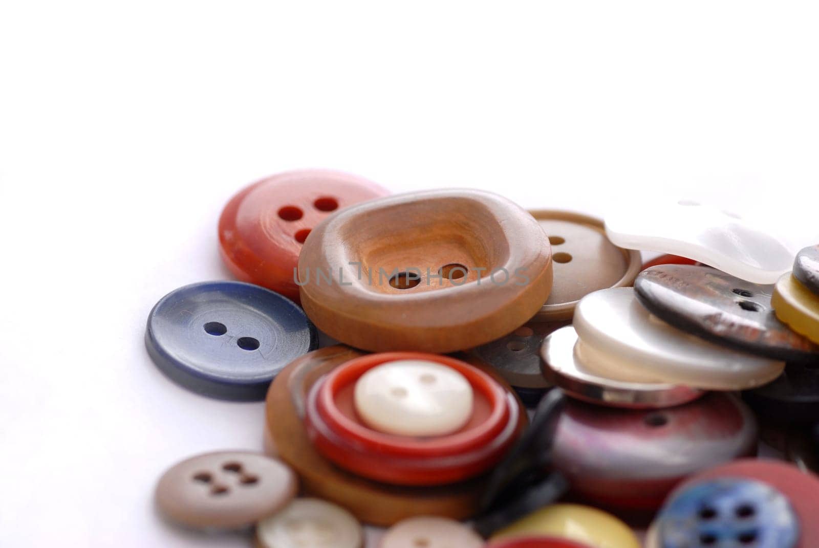 colored sewing buttons on a white background