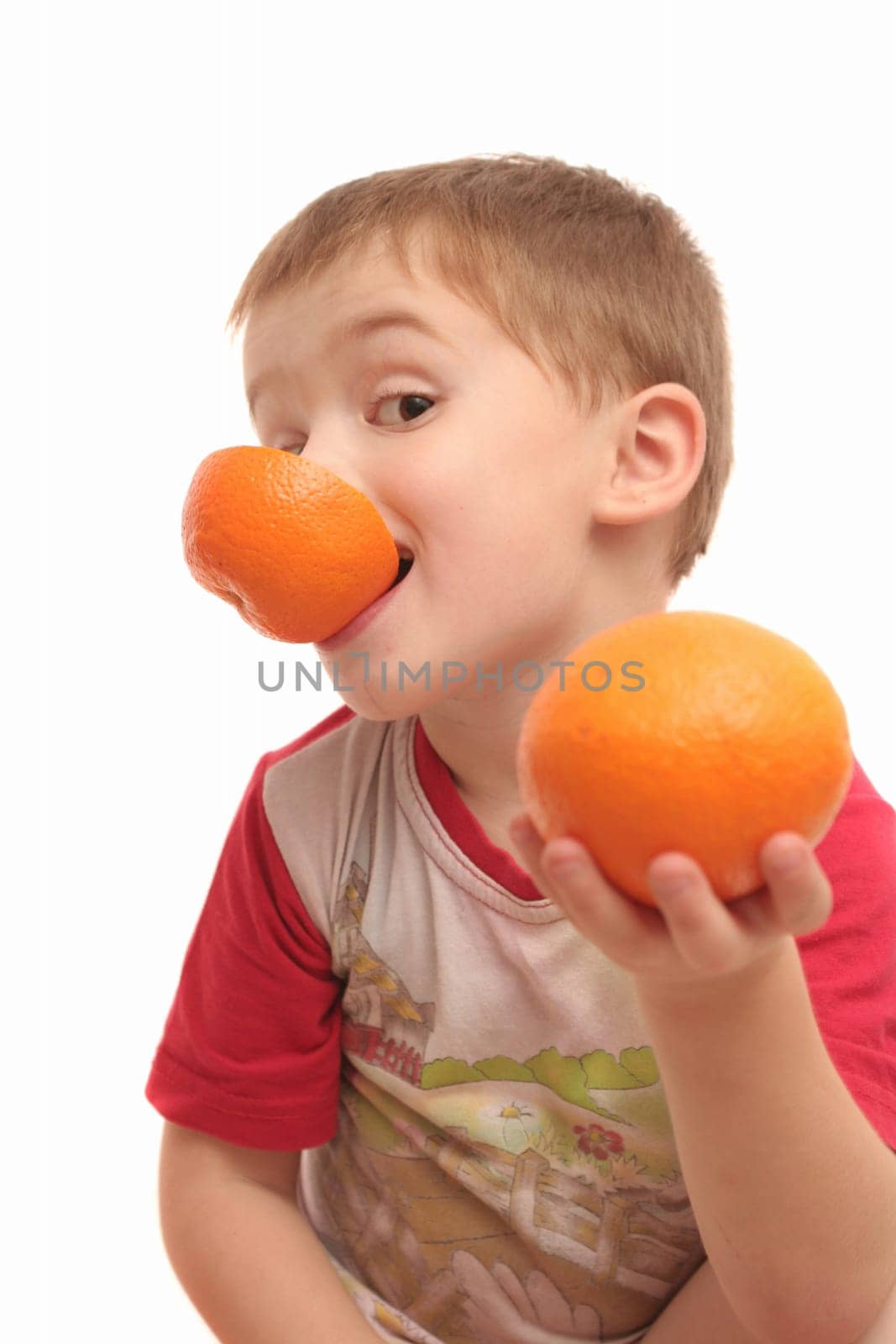 The boy on a white background with oranges