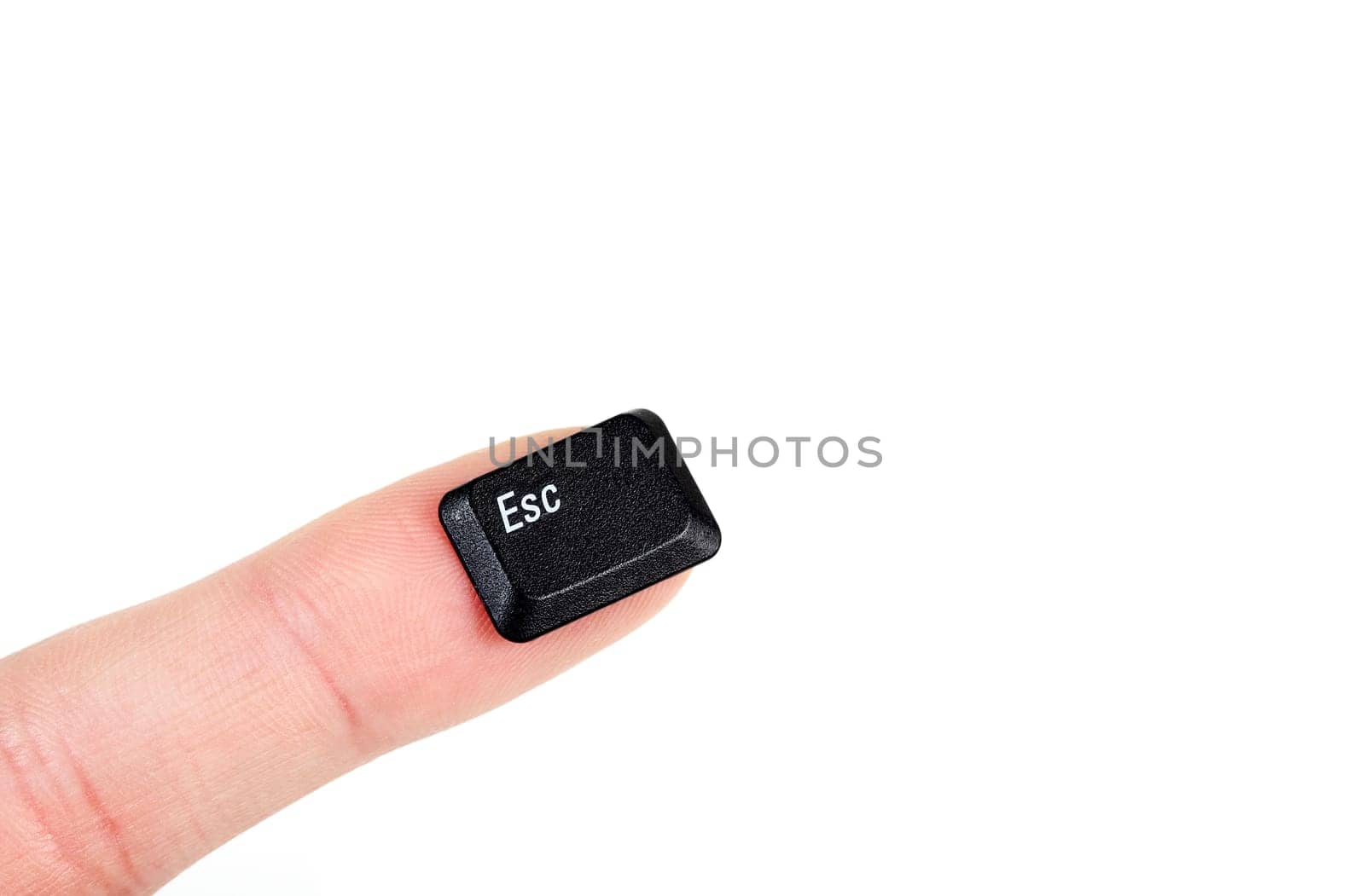 Finger holding the escape key, on white background