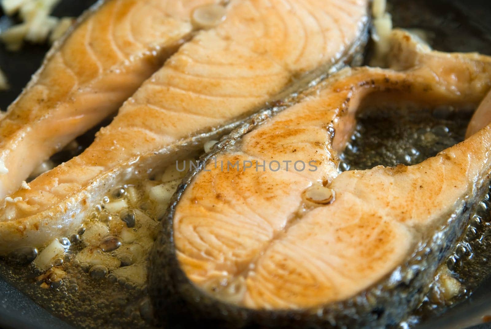Fillet salmon frying in a pan