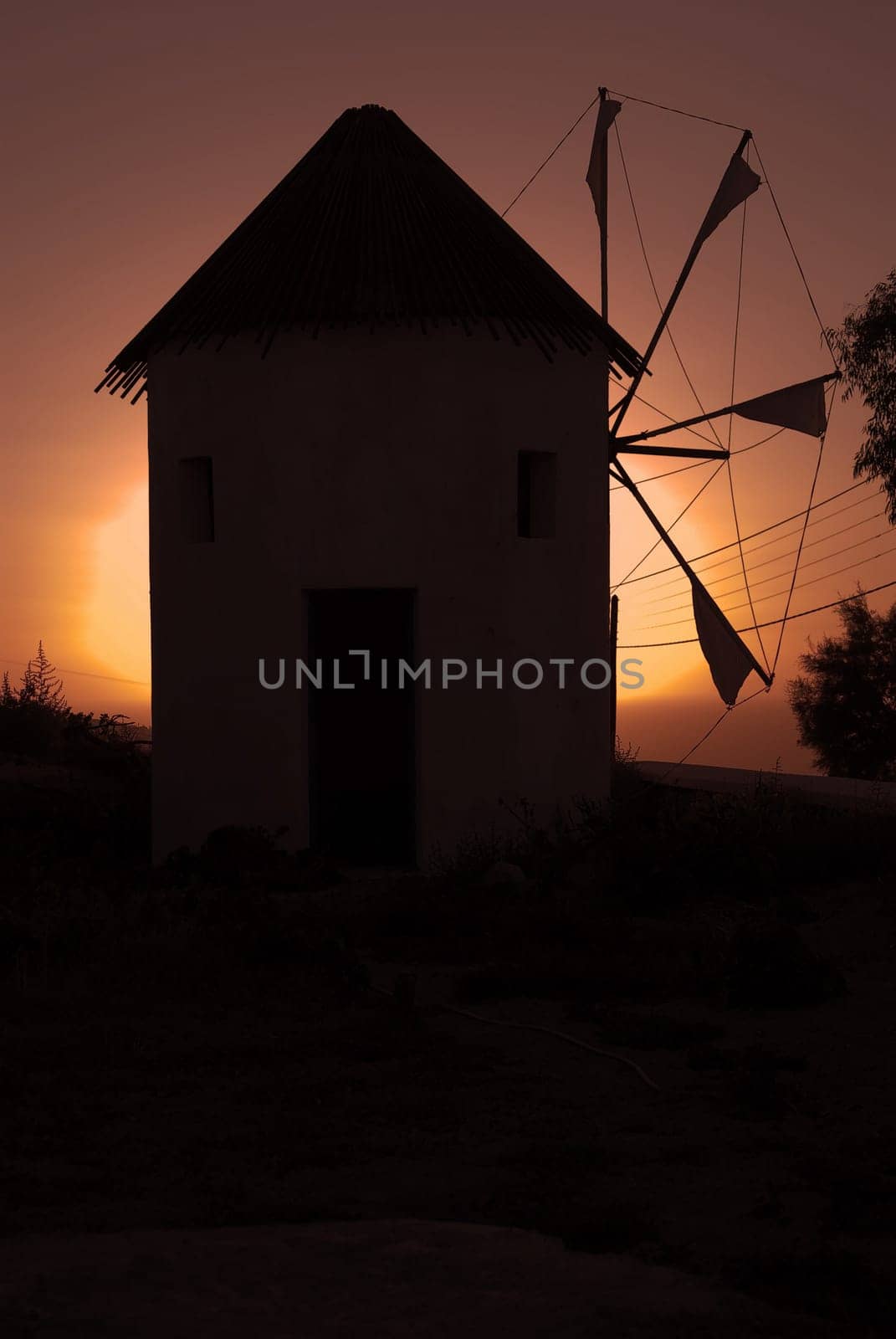 Windmill in the sunset of Santorini, Greece