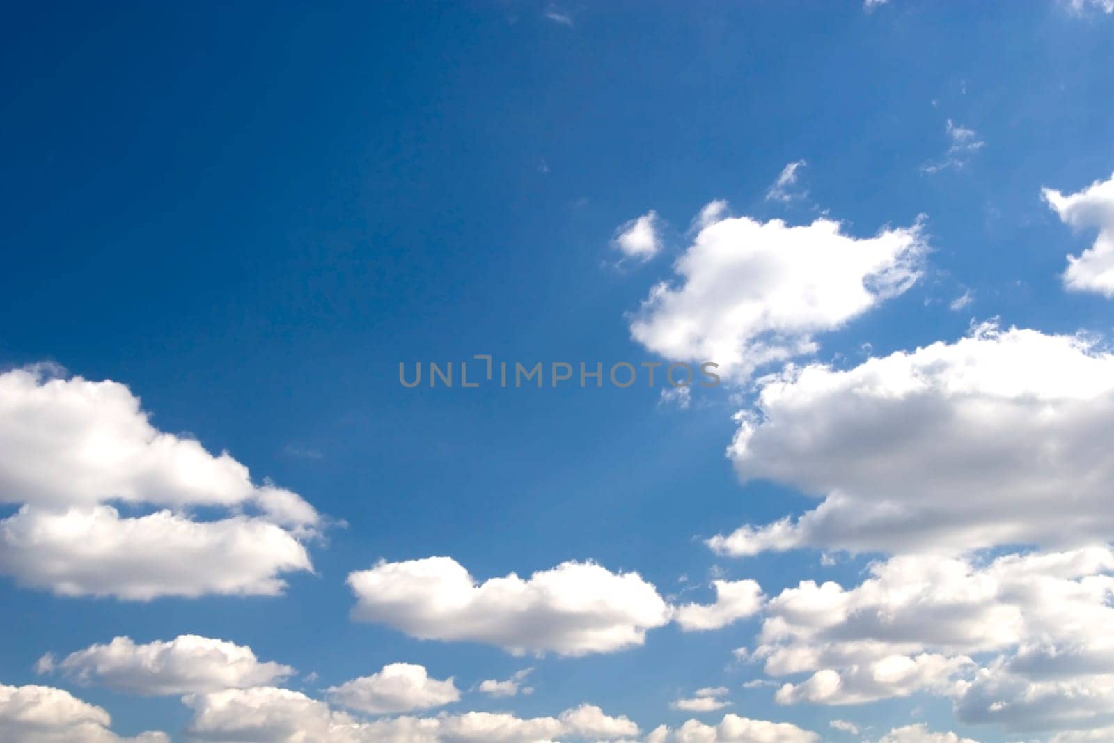 The blue sky and beautiful white clouds.
