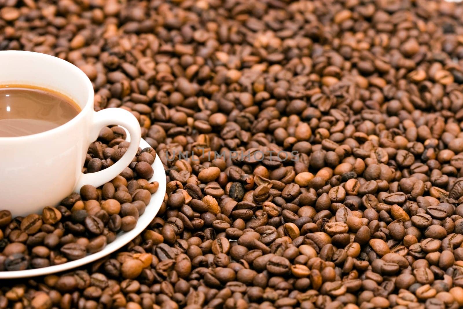 Coffe beans in cup on coffee background