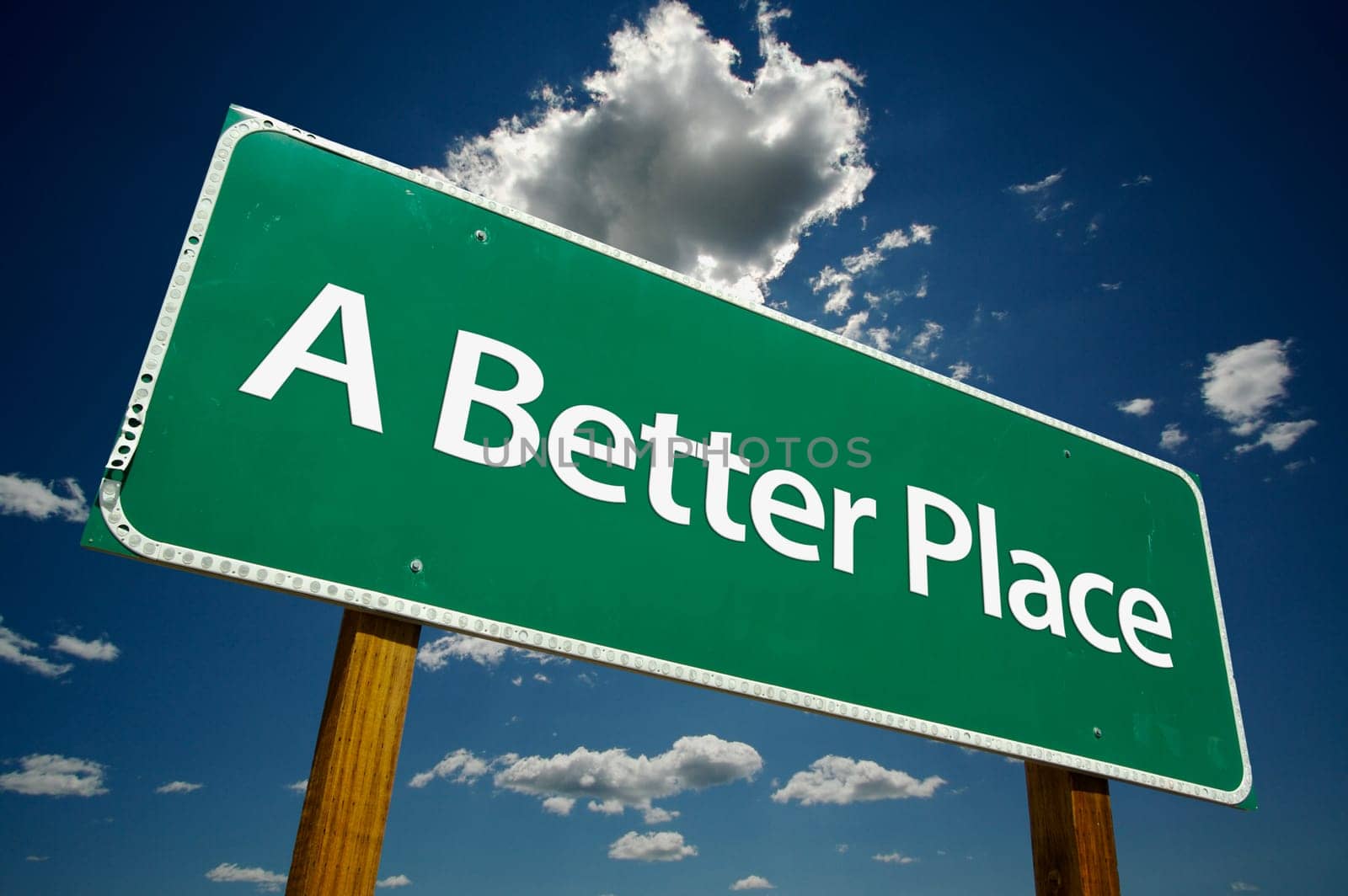 A Better Place Road Sign with dramatic blue sky and clouds.