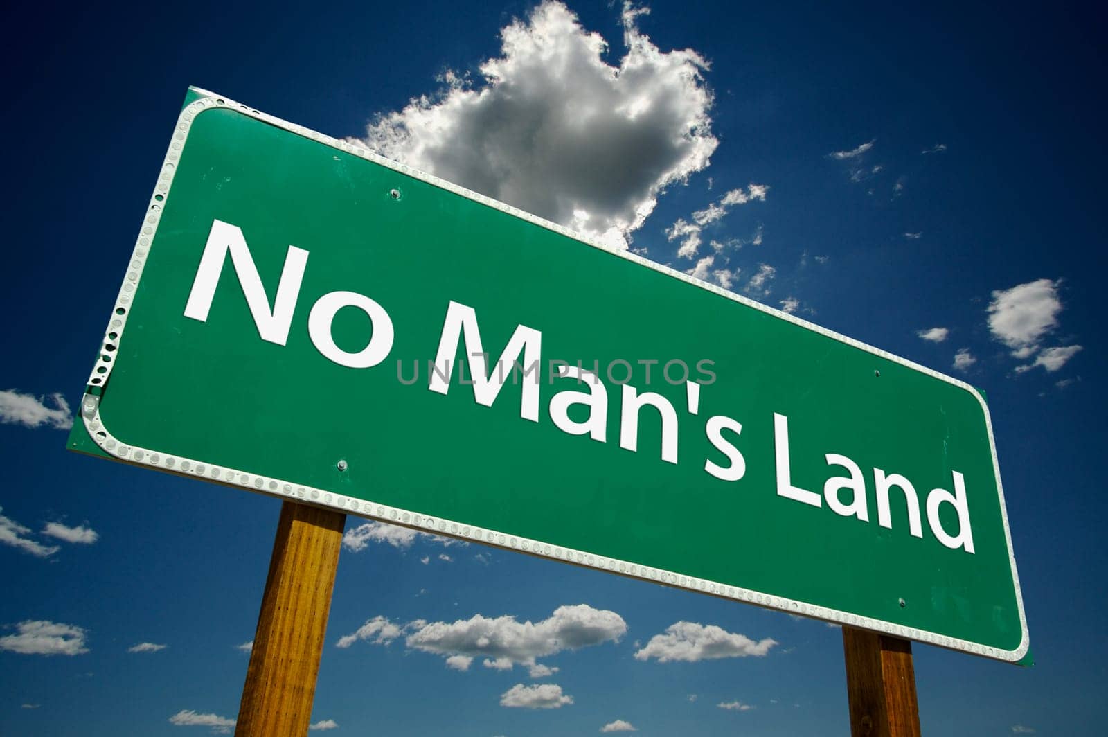 No Man's Land Road Sign with dramatic blue sky and clouds.