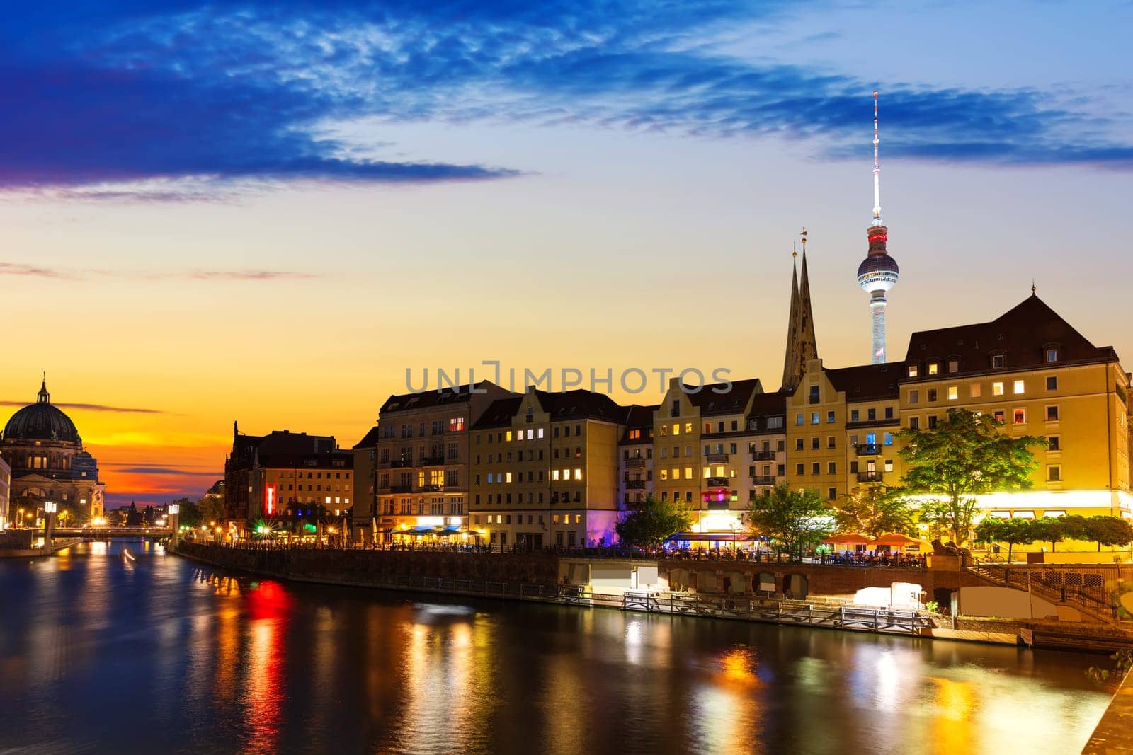 River Spree and the downtown buildings of Berlin, evening lights view, Germany.