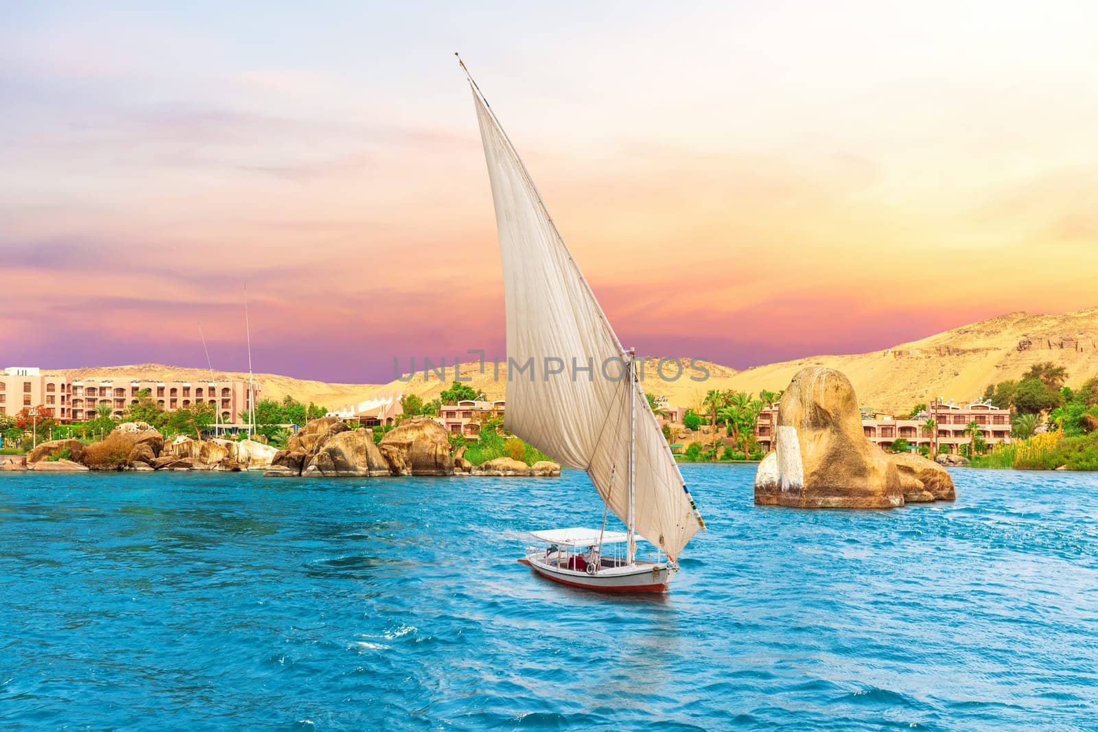 Famous sailboat and the Nile River scenery, sunset view, Aswan, Egypt .