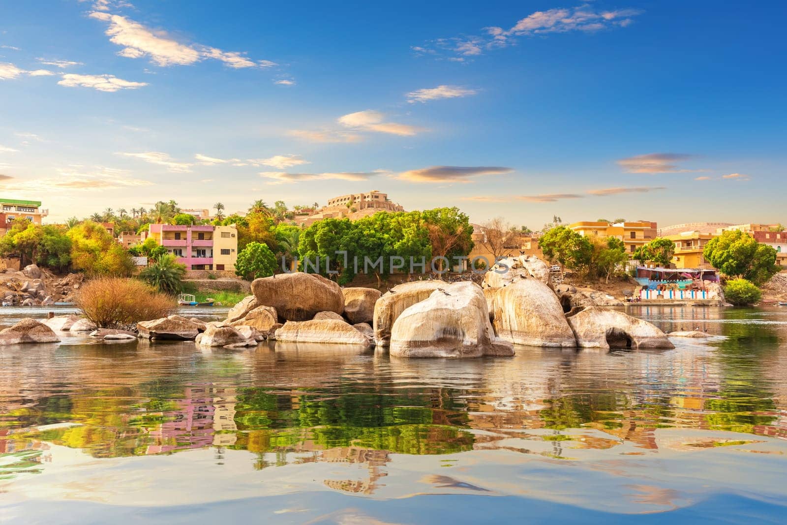 Picturesque banks of the Nile and traditional buildings of Aswan, Egypt.