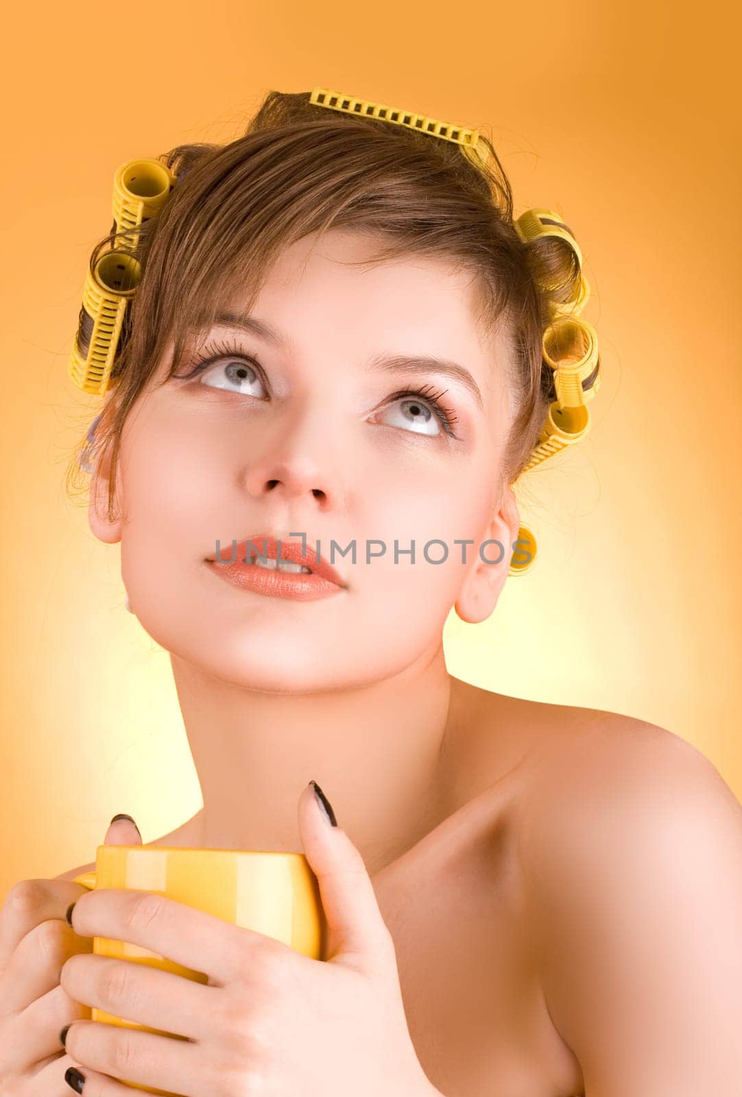 girl with hair-rollers holding a coffee cup