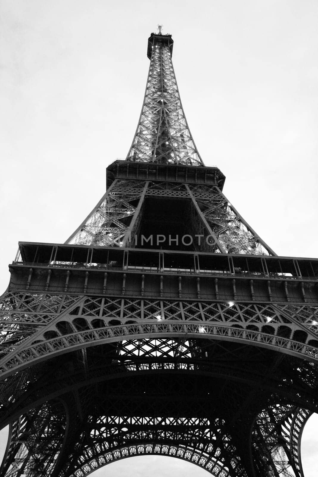 The black and white photo of Eiffel tower taken from below