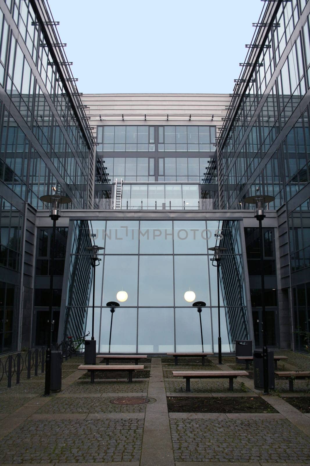 A modern office building of glass and steel seen from the front in perfect symmetry and balance