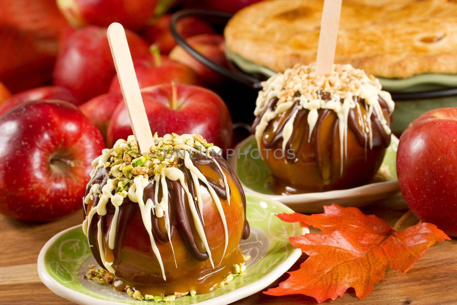 Caramel apples topped with chocolate and nuts