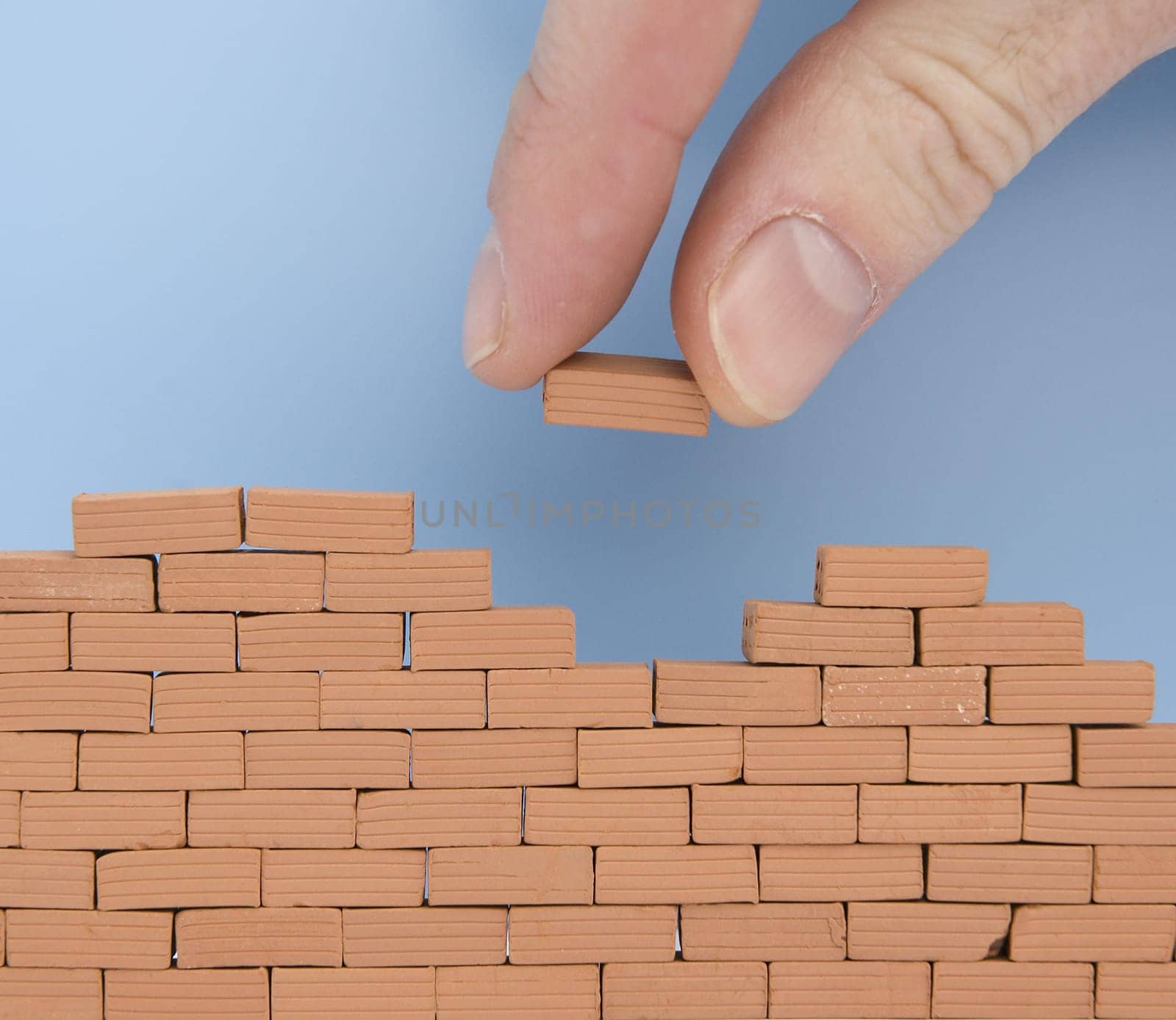 puting another brick on the wall