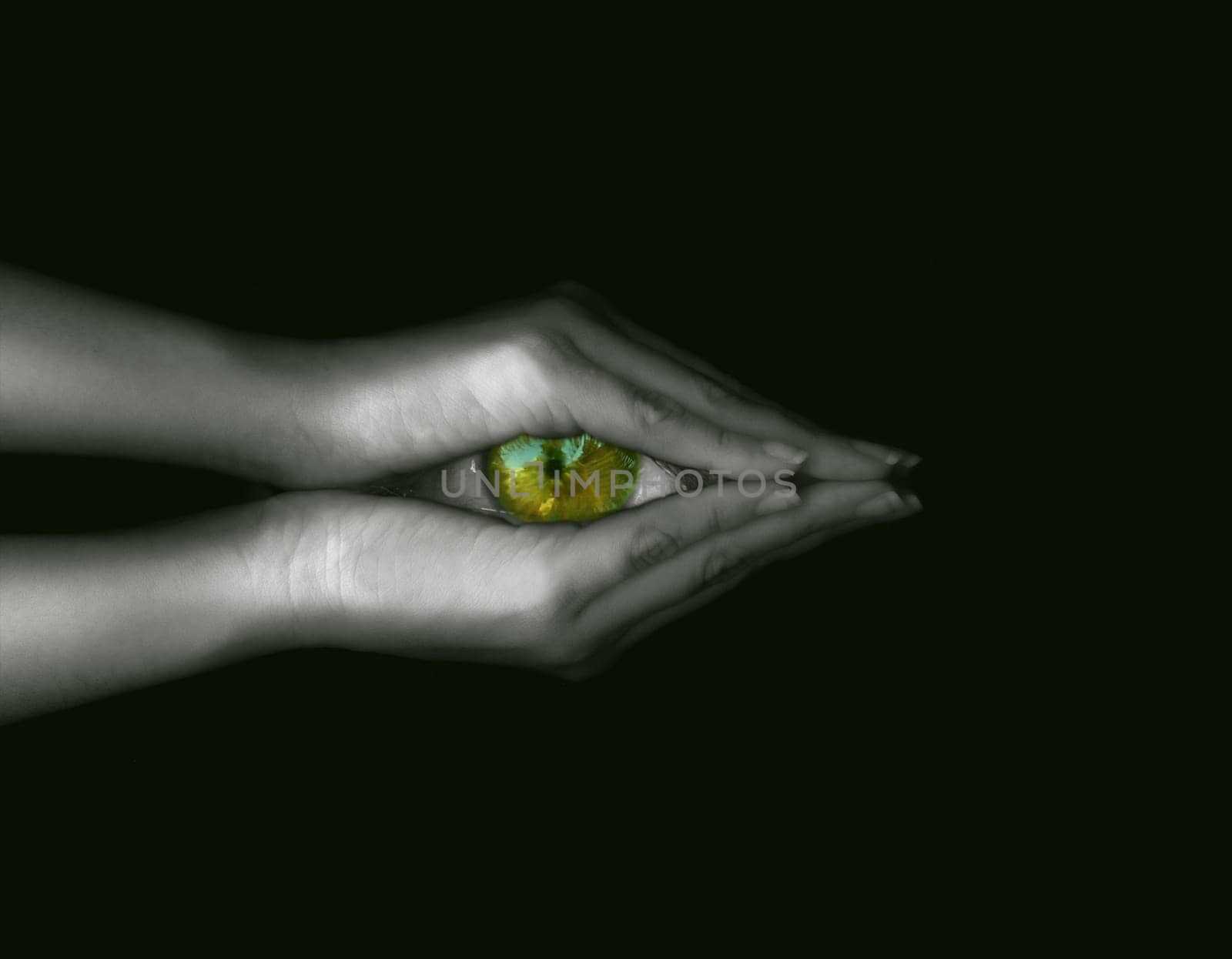 Hand holding green eye