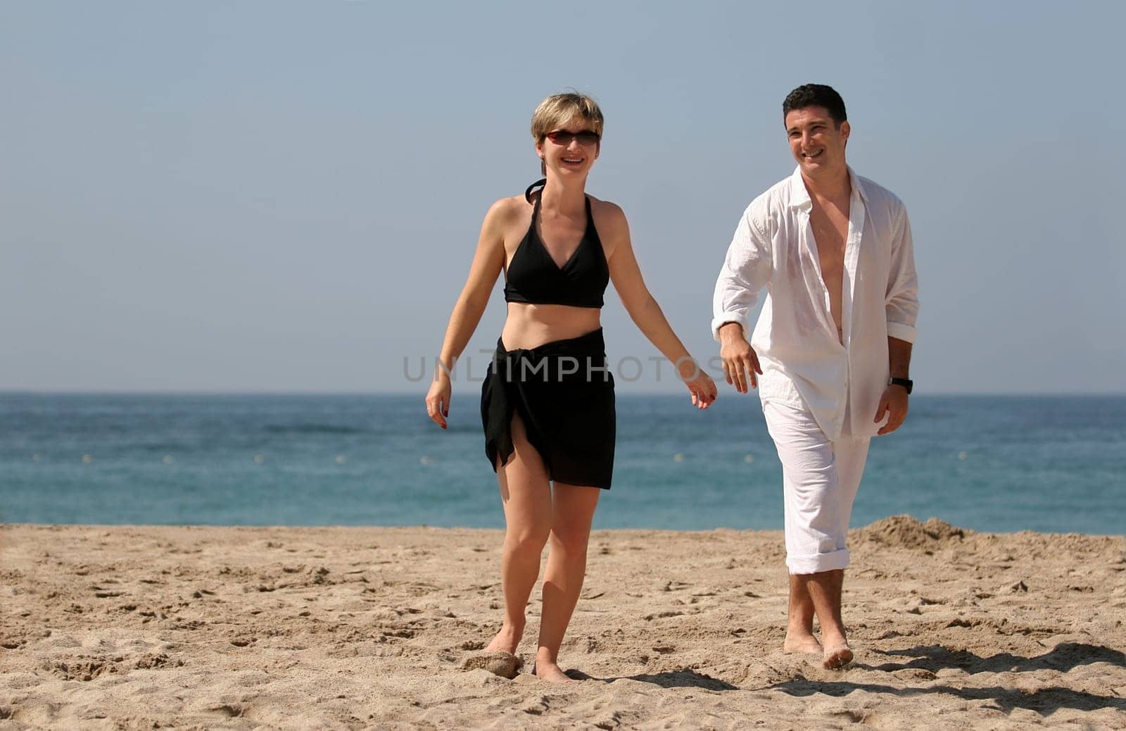 Young couple walking on the beach