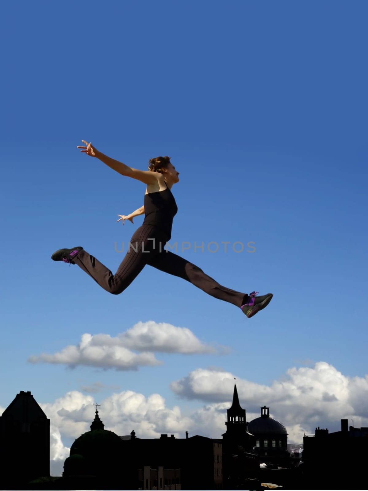 Young woman flying above the city